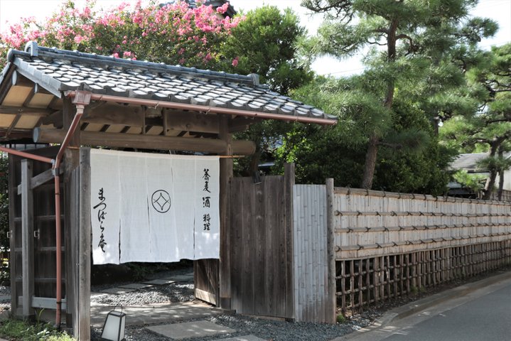 大きな木々に囲まれたどっしりとした日本家屋
